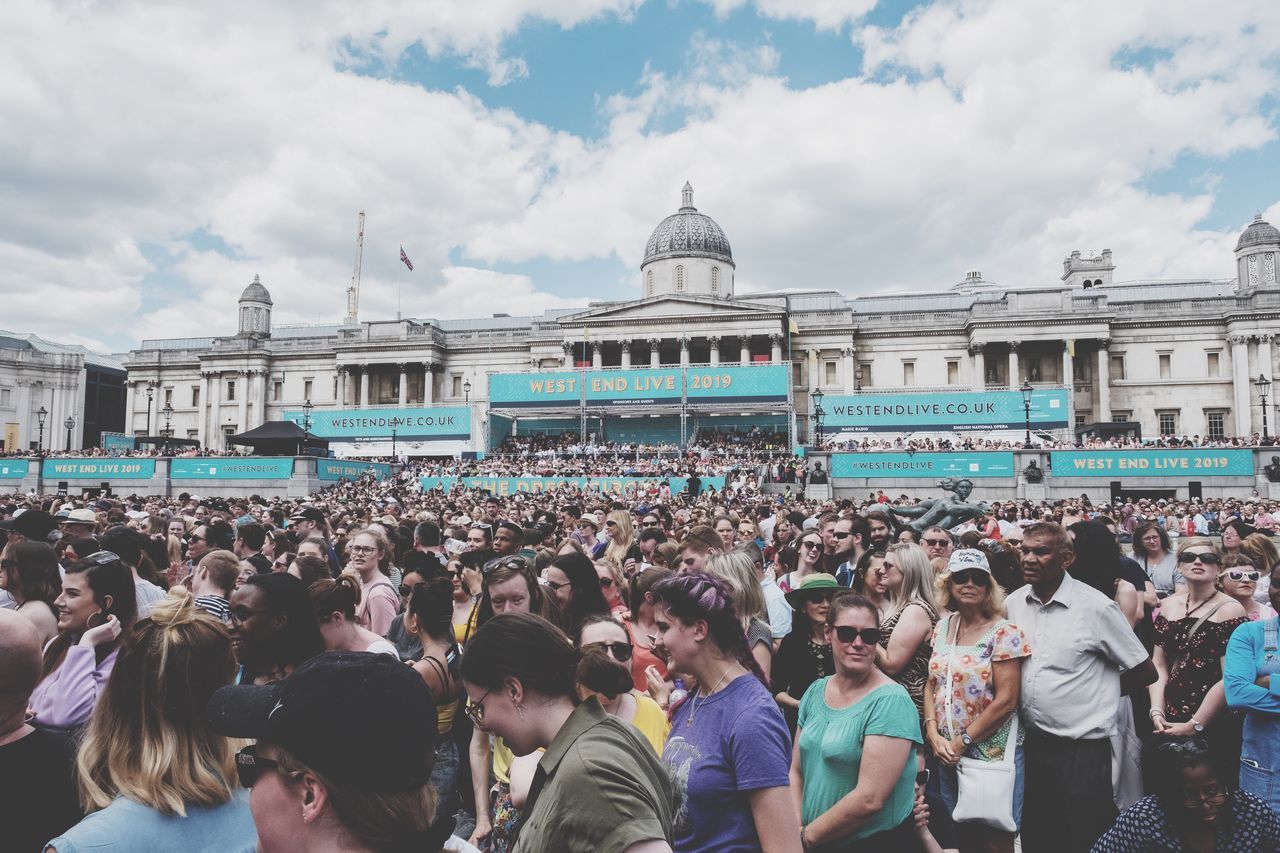 crowd, large group of people, real people, group of people, sky, cloud - sky, architecture, women, travel, men, built structure, day, lifestyles, travel destinations, tourism, adult, leisure activity, building exterior, outdoors, spectator