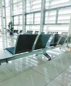 Empty chairs at airport departure area