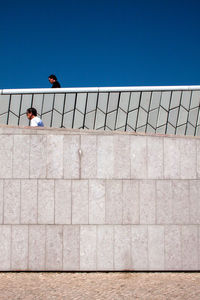 Low angle view of people on wall