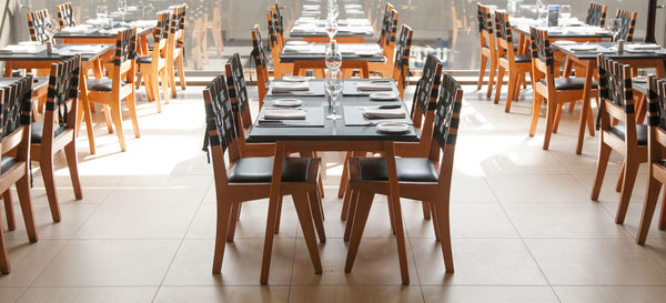 Empty chairs and tables in restaurant