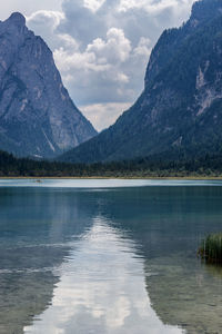 Scenic view of lake by mountains against sky