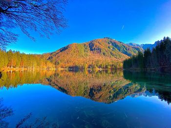 Scenic view of lake against blue sky during autumn