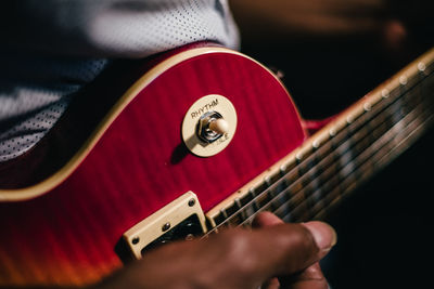 Cropped image of man playing guitar