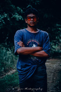 Portrait of young man wearing sunglasses standing outdoors