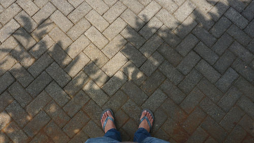 Low section of man standing on footpath