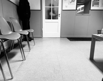Empty chairs and table in room