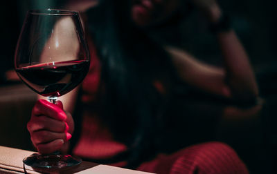 Close-up of woman holding wineglass