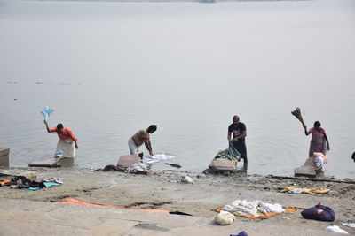 Group of people working on beach