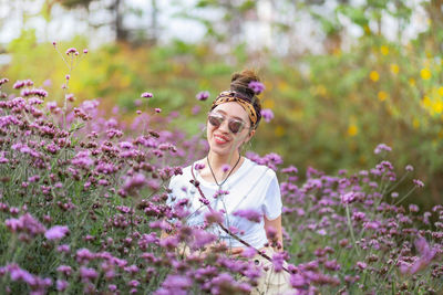 Woman standing on purple flowering plants