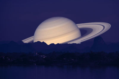 Scenic view of lake against sky at night