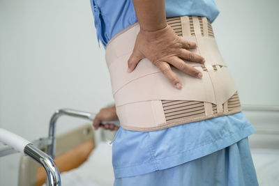 Midsection of woman holding bicycle