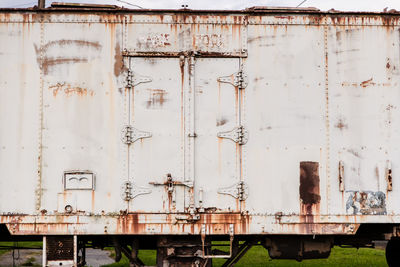 Abandoned train against building