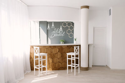 Stylish original bar counter with chairs in the living room in the interior of the house 