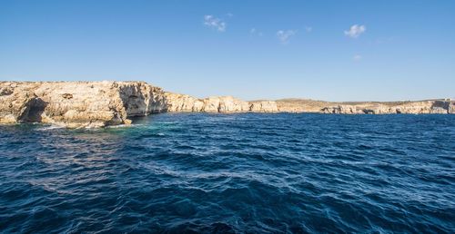 Scenic view of sea against clear blue sky