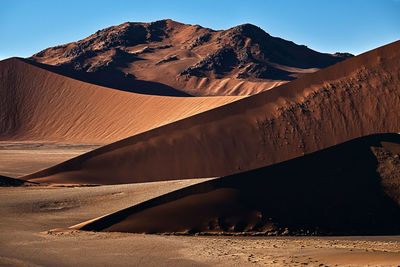 Sand dune blades fading into namib desert in africa