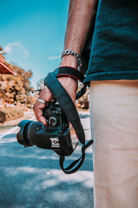 Close-up of man photographing camera