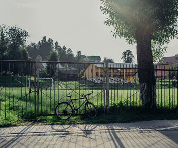 Bicycle parked by gate