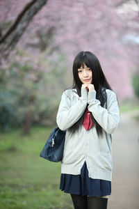 Portrait of a beautiful young woman standing outdoors