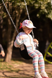 Portrait of little girl swinging