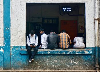 Rear view of people walking in city