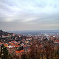 Cityscape against cloudy sky