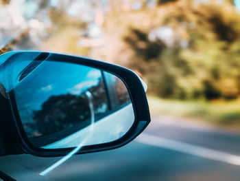 Close-up of reflection on side-view mirror