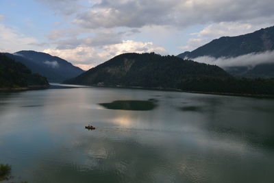 Scenic view of lake and mountains against sky