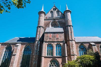 Low angle view of building against clear blue sky