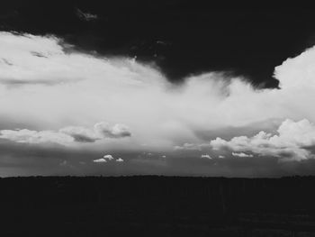 Scenic view of silhouette field against sky