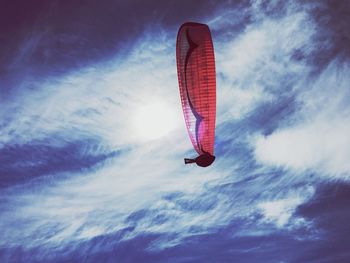 Low angle view of paragliding against sky