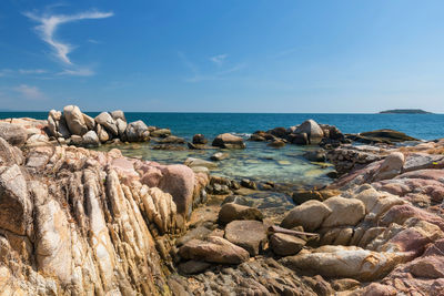 Rocks on beach against sky