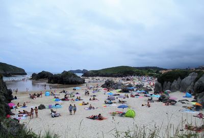 People on beach against sky