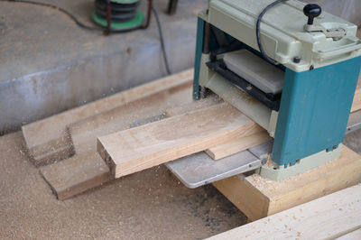 High angle view of plank and work tools on table