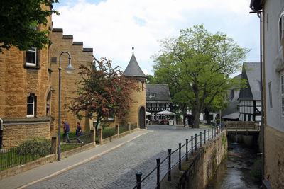 Street amidst buildings against sky