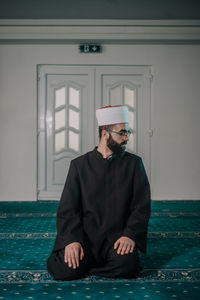 Portrait of young man sitting at home