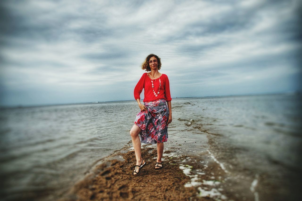water, sea, full length, sky, horizon over water, beach, lifestyles, leisure activity, standing, shore, casual clothing, cloud - sky, scenics, tranquil scene, tranquility, vacations, rear view, beauty in nature