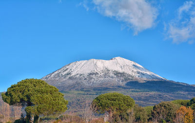 Scenic view of volcanic mountain against blue sky