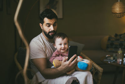 Mother and daughter while using smart phone