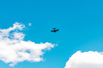 Low angle view of airplane flying in sky