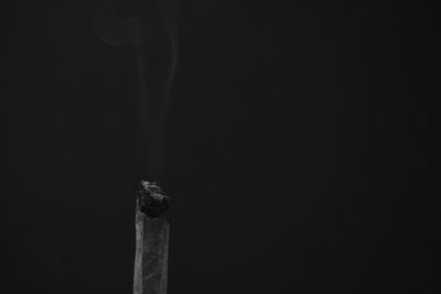 Close-up of cigarette against black background