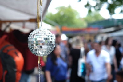 Close-up of disco ball hanging in stall at amusement park