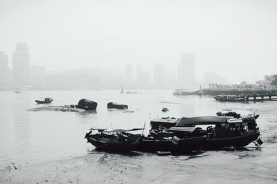 Boat in river with city in background