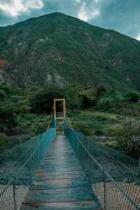 Footbridge leading towards mountains