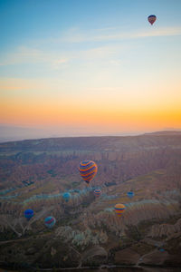 Hot air balloons against sky during sunset