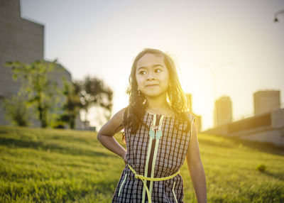 Portrait of teenage girl standing against sky