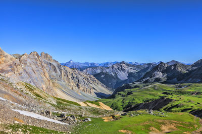 Scenic view of mountains against clear blue sky
