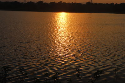 Scenic view of lake against sky during sunset