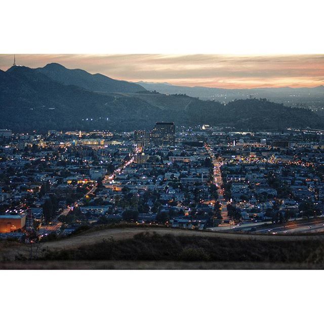 cityscape, city, building exterior, architecture, mountain, built structure, illuminated, crowded, high angle view, landscape, residential district, mountain range, sky, residential building, aerial view, clear sky, copy space, scenics, residential structure, outdoors