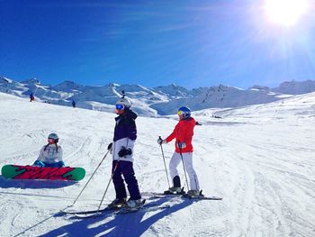 Tourists on snow covered mountain