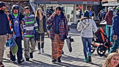 Full length of friends standing in city